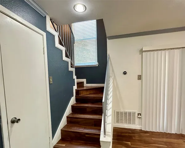 a view of entryway with wooden floor and stairs