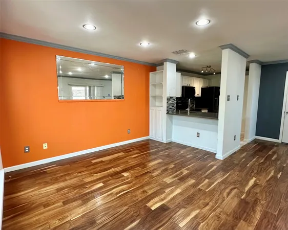 a kitchen with stainless steel appliances a stove microwave and sink