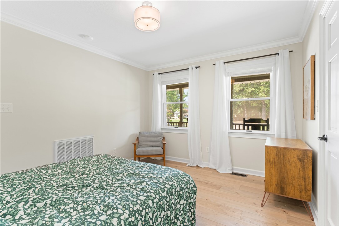622 Jackson Road Anderson, SC 29626 - Photo 12 of 50 Blonde hardwood floors grace this bedroom, illuminated by two sun-filled windows.