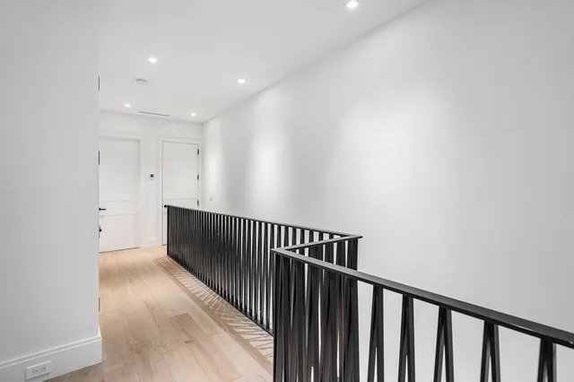 a view of hallway with wooden floor