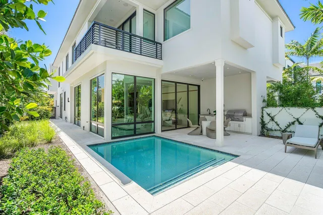 a swimming pool with outdoor seating and yard