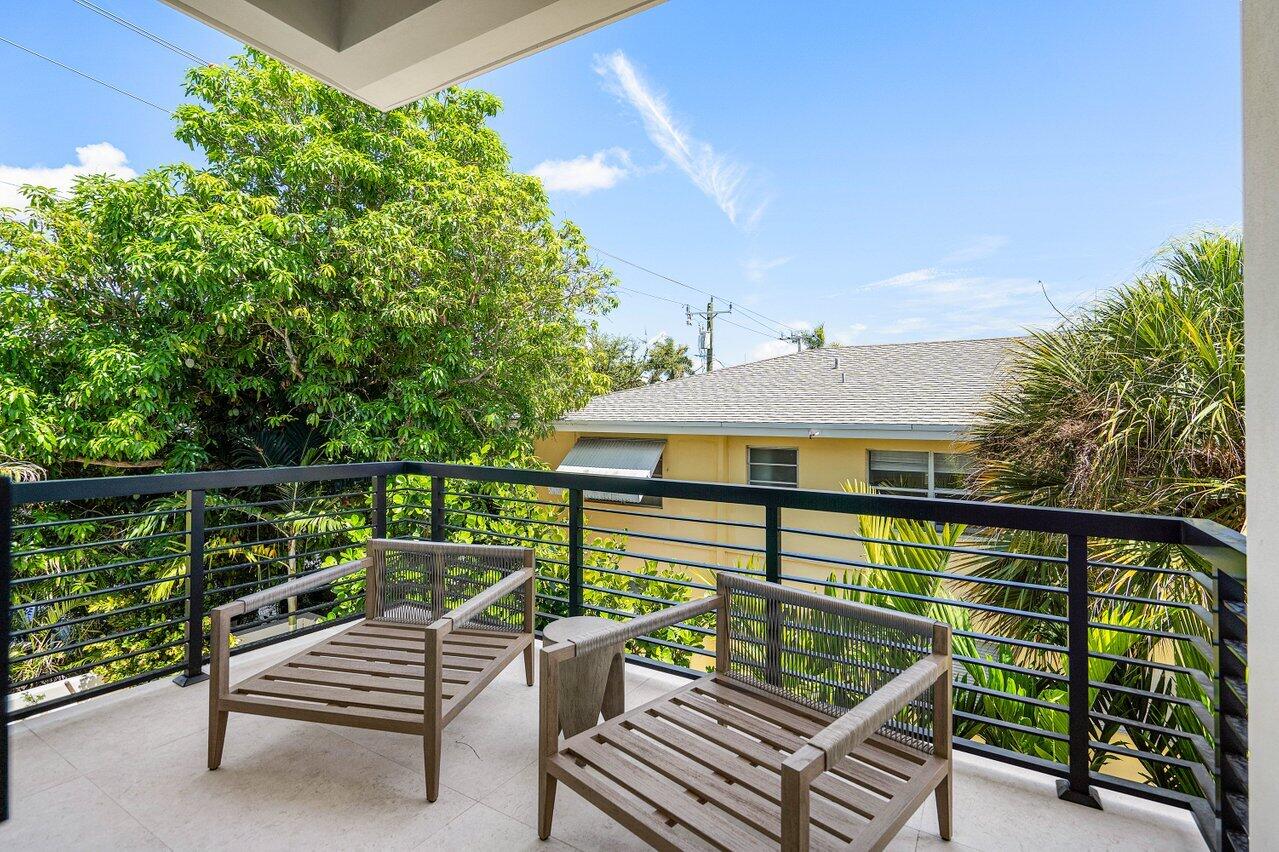 514 Northeast 7th Avenue Delray Beach, FL 33483 - Photo 28 of 51 a view of a roof deck with wooden fence and bench