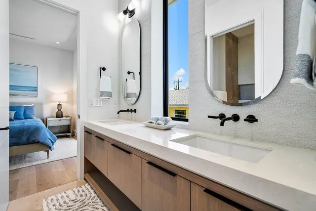 a bedroom with a bed and a flat tv screen on dresser