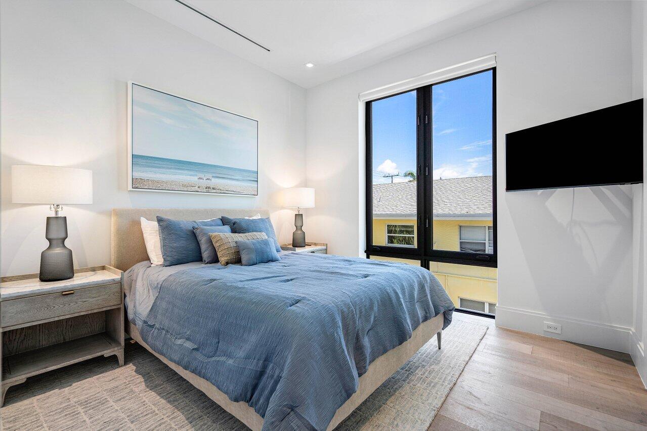 514 Northeast 7th Avenue Delray Beach, FL 33483 - Photo 41 of 51 a bedroom with a bed and a flat tv screen on dresser