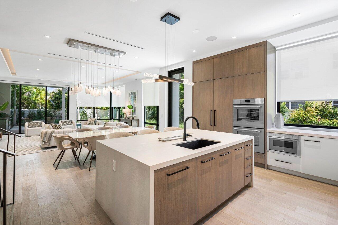 514 Northeast 7th Avenue Delray Beach, FL 33483 - Photo 9 of 51 a kitchen with a stove a sink and a refrigerator