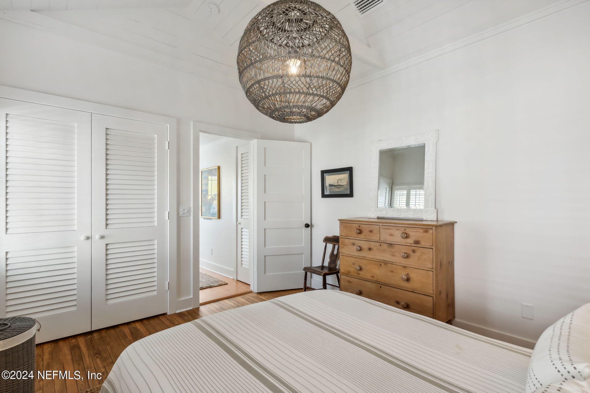 232 South 7th Street Fernandina Beach, FL 32034 - Photo 24 of 43 a bedroom with a bed and a chandelier