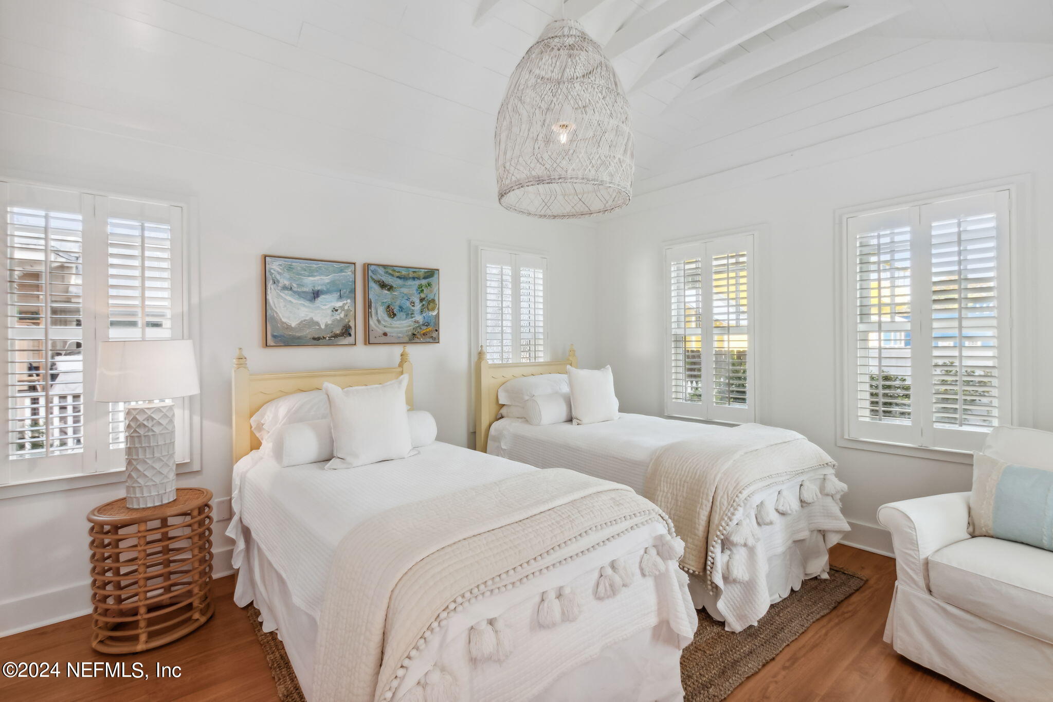 232 South 7th Street Fernandina Beach, FL 32034 - Photo 27 of 43 a bedroom with a bed and a chandelier