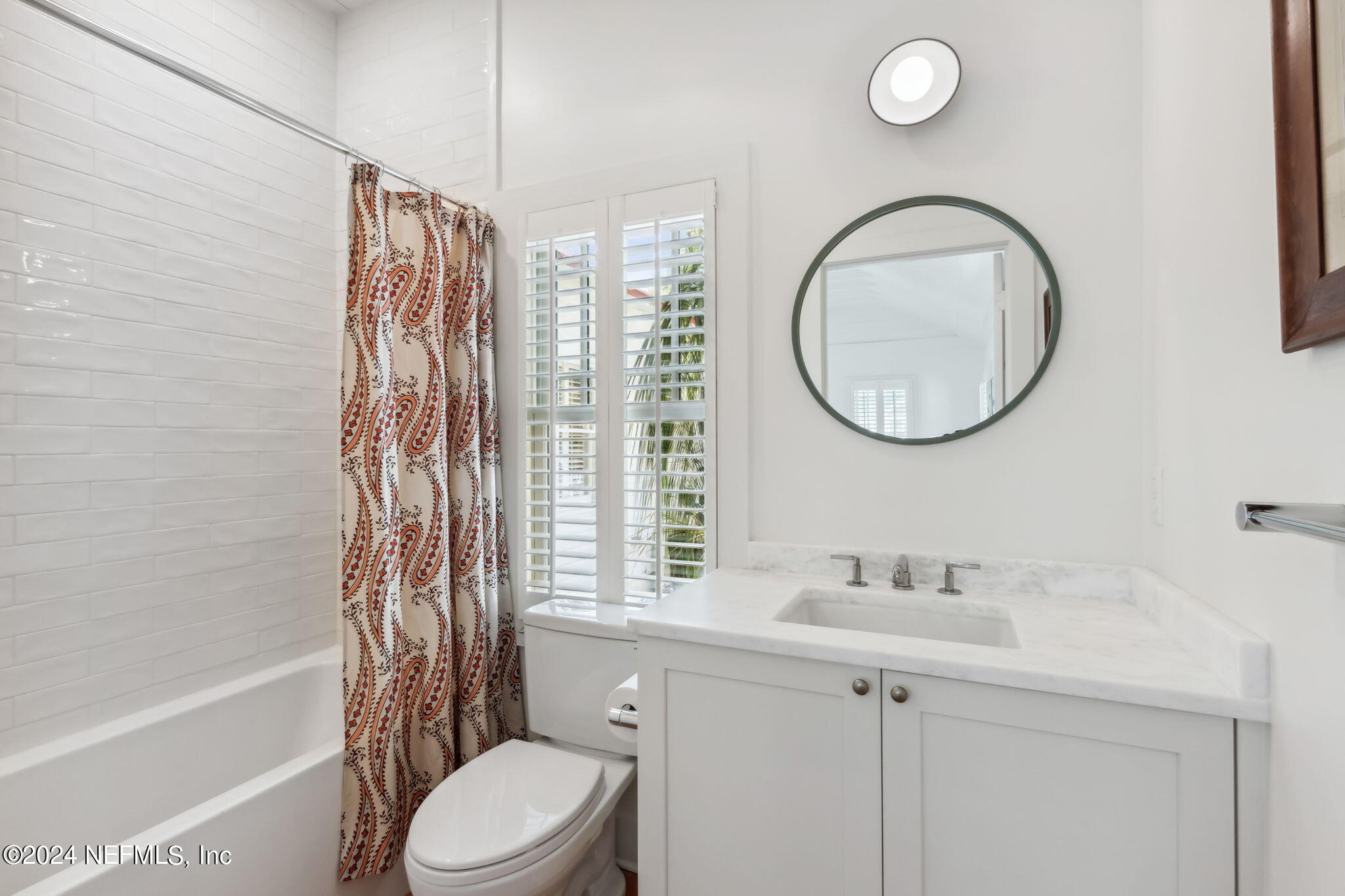232 South 7th Street Fernandina Beach, FL 32034 - Photo 29 of 43 a bathroom with a sink a toilet and a mirror