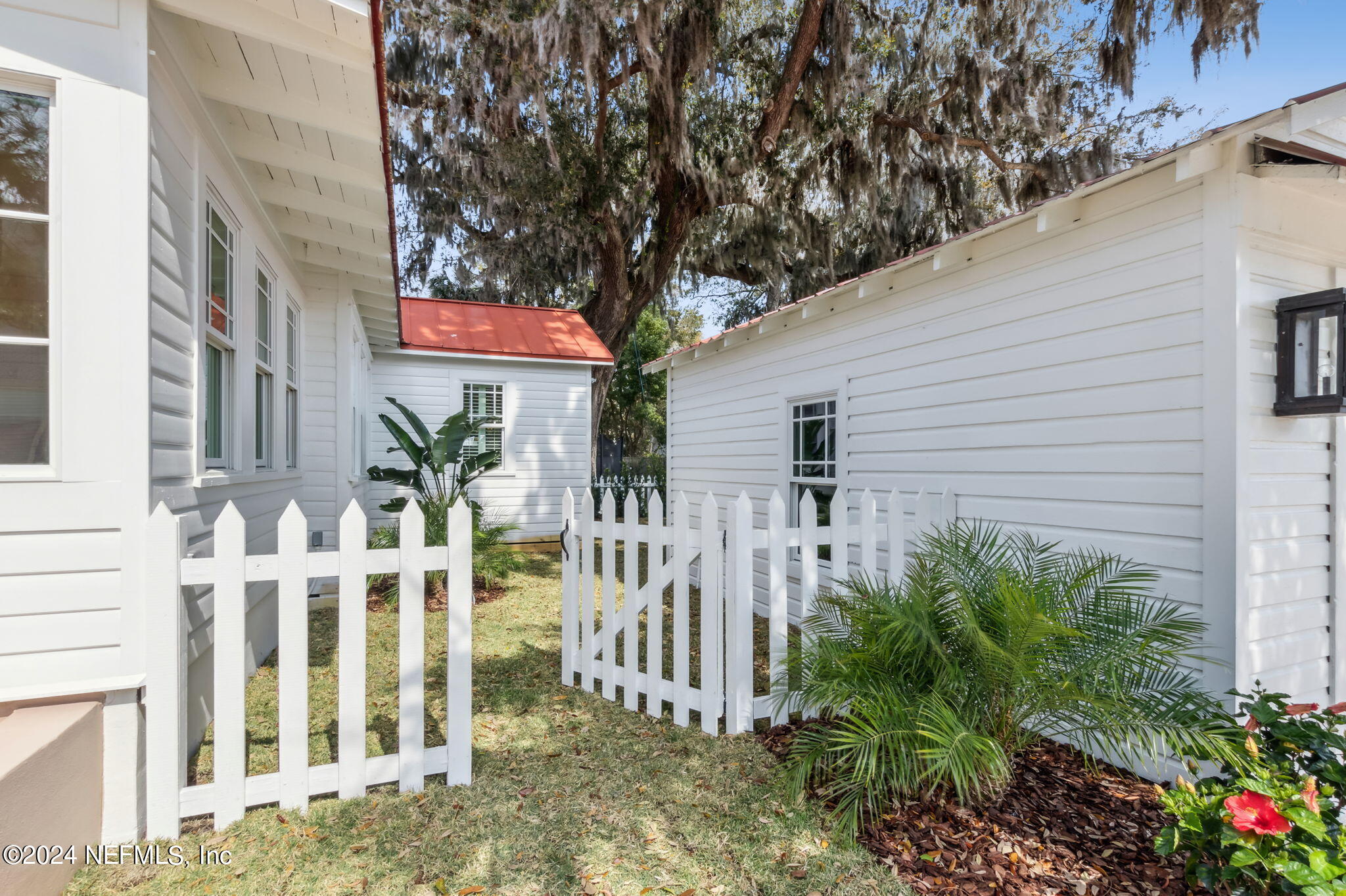 232 South 7th Street Fernandina Beach, FL 32034 - Photo 31 of 43 a view of a house with a small yard and plants