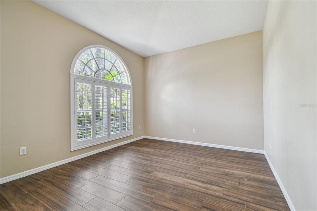 19331 Wind Dancer Street Lutz, FL 33558 - Photo 12 of 92 an empty room with wooden floor and windows