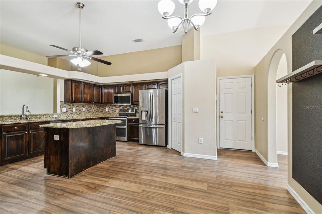 19331 Wind Dancer Street Lutz, FL 33558 - Photo 19 of 92 a large kitchen with granite countertop a refrigerator and wooden floor