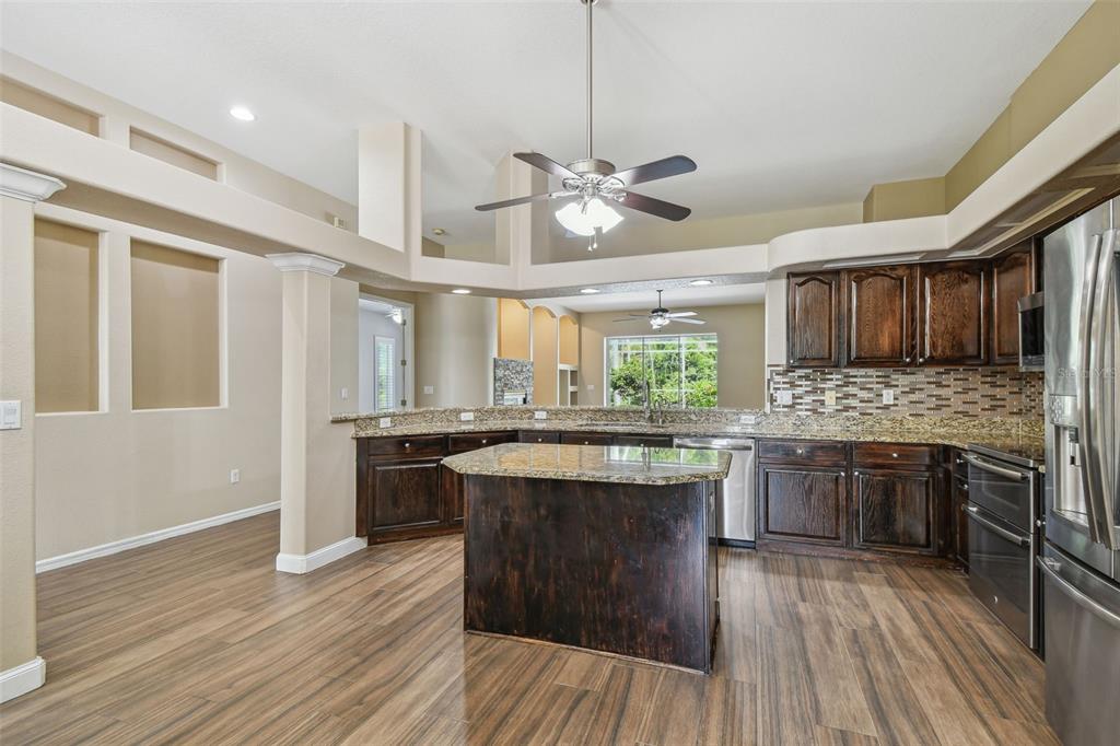 19331 Wind Dancer Street Lutz, FL 33558 - Photo 22 of 92 a kitchen with stainless steel appliances granite countertop wooden floors and sink