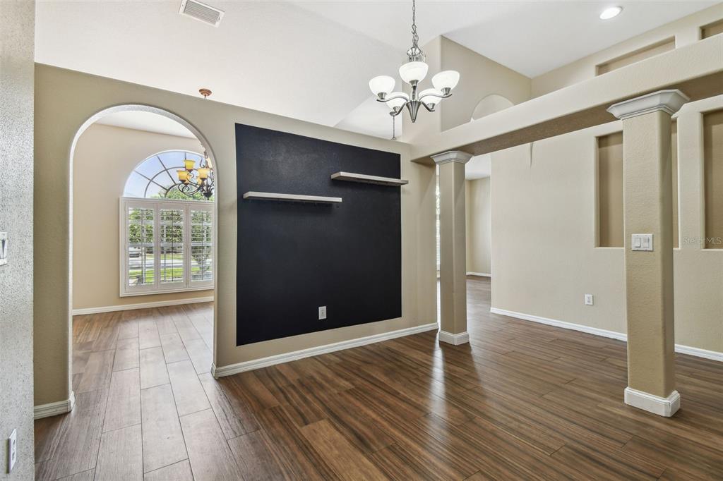19331 Wind Dancer Street Lutz, FL 33558 - Photo 28 of 92 a view of a livingroom with wooden floor and chandelier