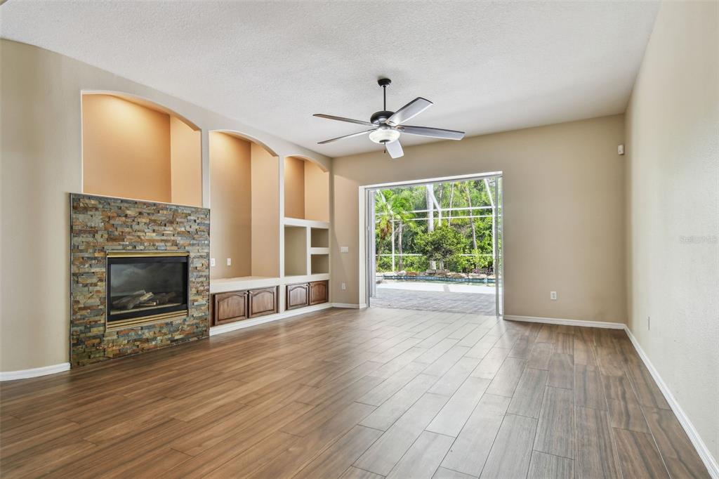 19331 Wind Dancer Street Lutz, FL 33558 - Photo 31 of 92 a view of an empty room with a window and wooden floor