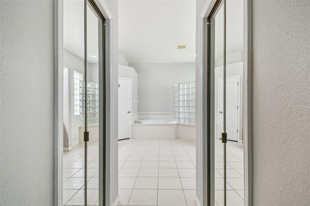 19331 Wind Dancer Street Lutz, FL 33558 - Photo 45 of 92 a bathroom with a glass shower door and a bathtub