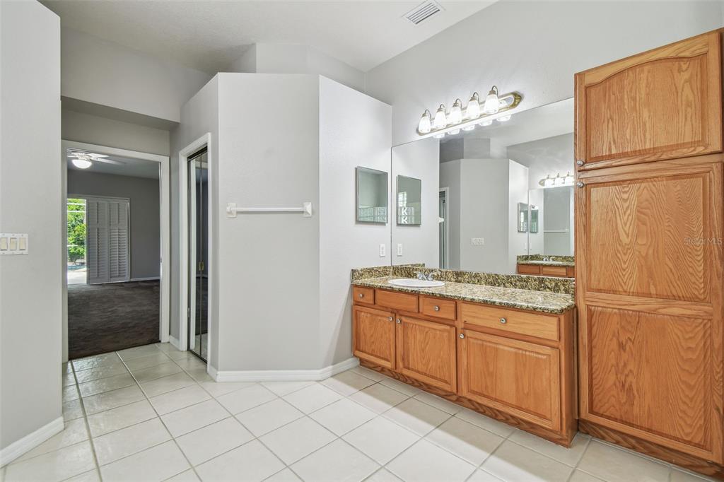 19331 Wind Dancer Street Lutz, FL 33558 - Photo 49 of 92 a kitchen with stainless steel appliances granite countertop a refrigerator and a stove