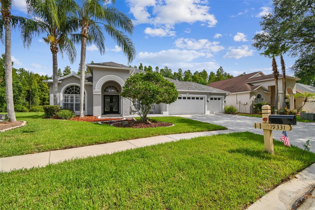 19331 Wind Dancer Street Lutz, FL 33558 - Photo 5 of 92 a front view of a house with a garden