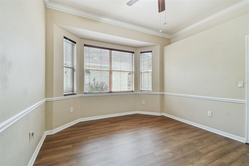19331 Wind Dancer Street Lutz, FL 33558 - Photo 56 of 92 an empty room with wooden floor and windows
