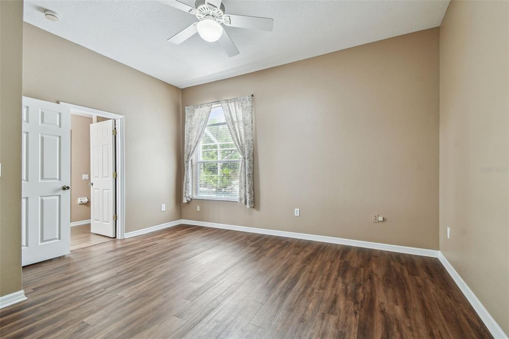 19331 Wind Dancer Street Lutz, FL 33558 - Photo 60 of 92 a view of an empty room with wooden floor and a window