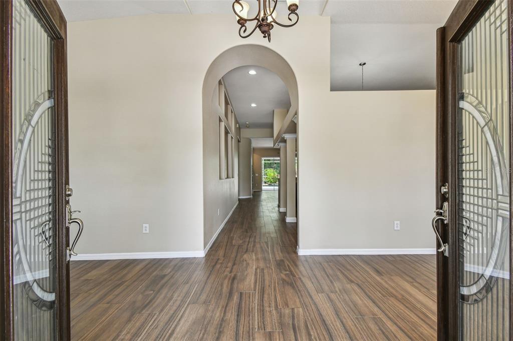 19331 Wind Dancer Street Lutz, FL 33558 - Photo 9 of 92 a view of a hallway view with wooden floor and staircase