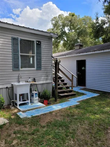 a house view with a sitting space and garden