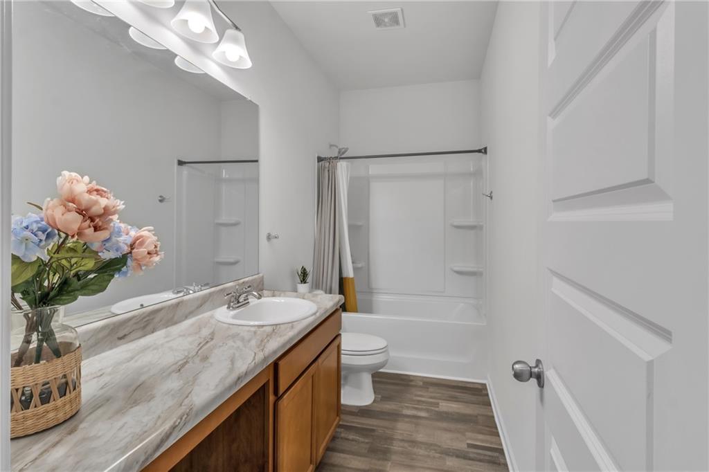 97 Crossroad Circle Jasper, GA 30143 - Photo 17 of 28 a bathroom with a granite countertop sink a toilet and shower
