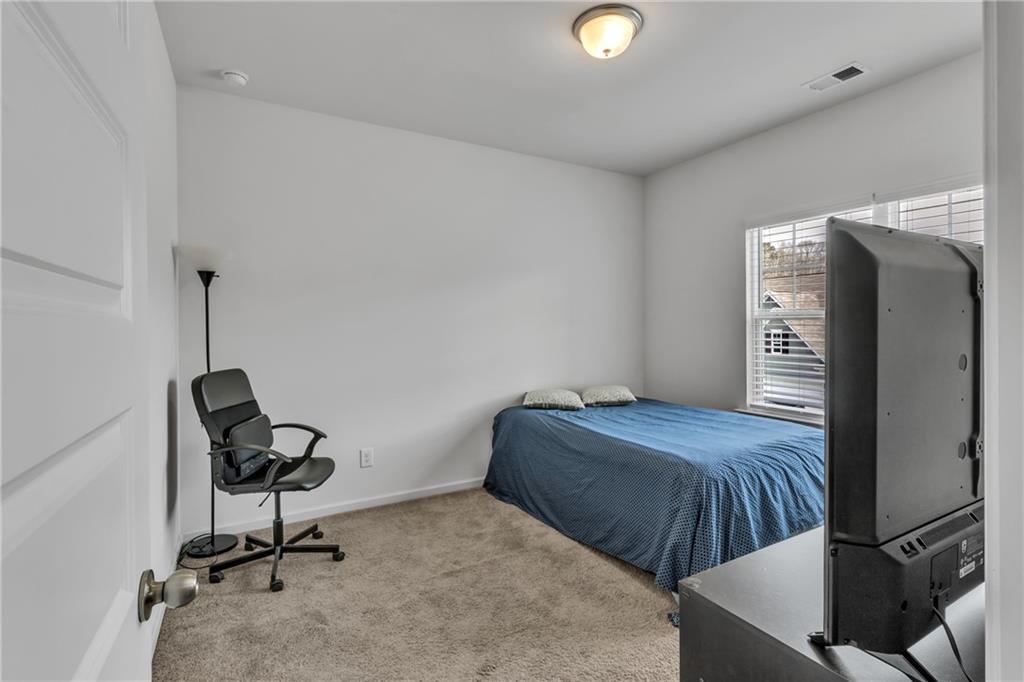 97 Crossroad Circle Jasper, GA 30143 - Photo 19 of 28 a bedroom with a bed and a chair