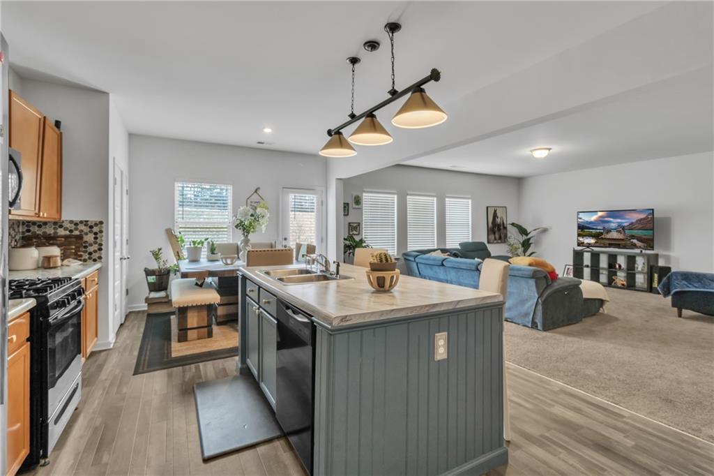 97 Crossroad Circle Jasper, GA 30143 - Photo 2 of 28 a kitchen with stainless steel appliances granite countertop a sink a stove and a refrigerator