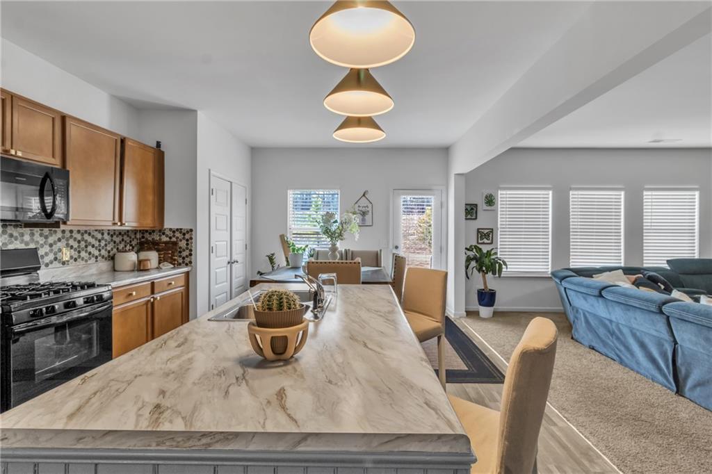 97 Crossroad Circle Jasper, GA 30143 - Photo 3 of 28 a kitchen with sink refrigerator dining table and chairs