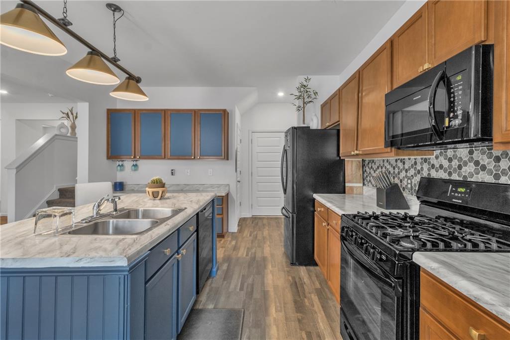 97 Crossroad Circle Jasper, GA 30143 - Photo 10 of 28 a kitchen with stainless steel appliances granite countertop a sink stove and refrigerator