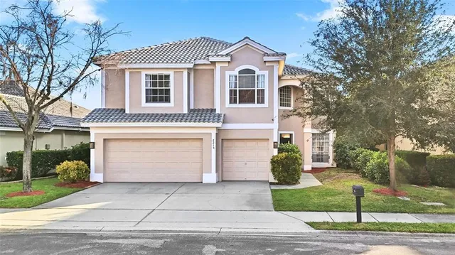 a front view of a house with a garden and plants