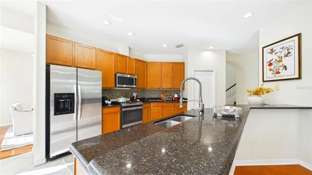a view of a dining room with furniture wooden floor and a chandelier