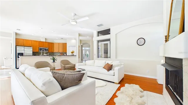 a living room with furniture a fireplace and a large window
