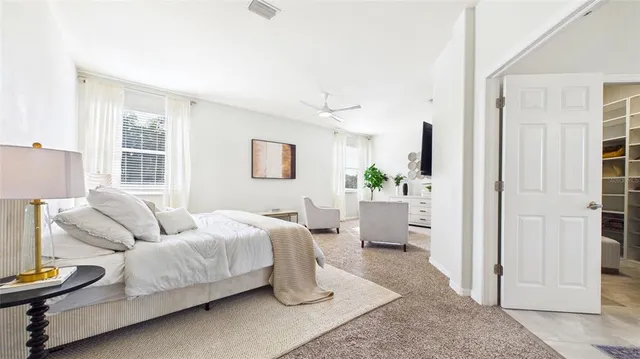 a view of walk in closet with clothes and shoes