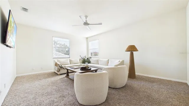 a living room with furniture and a large window