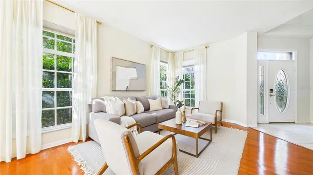 a living room with furniture a fireplace and a potted plant