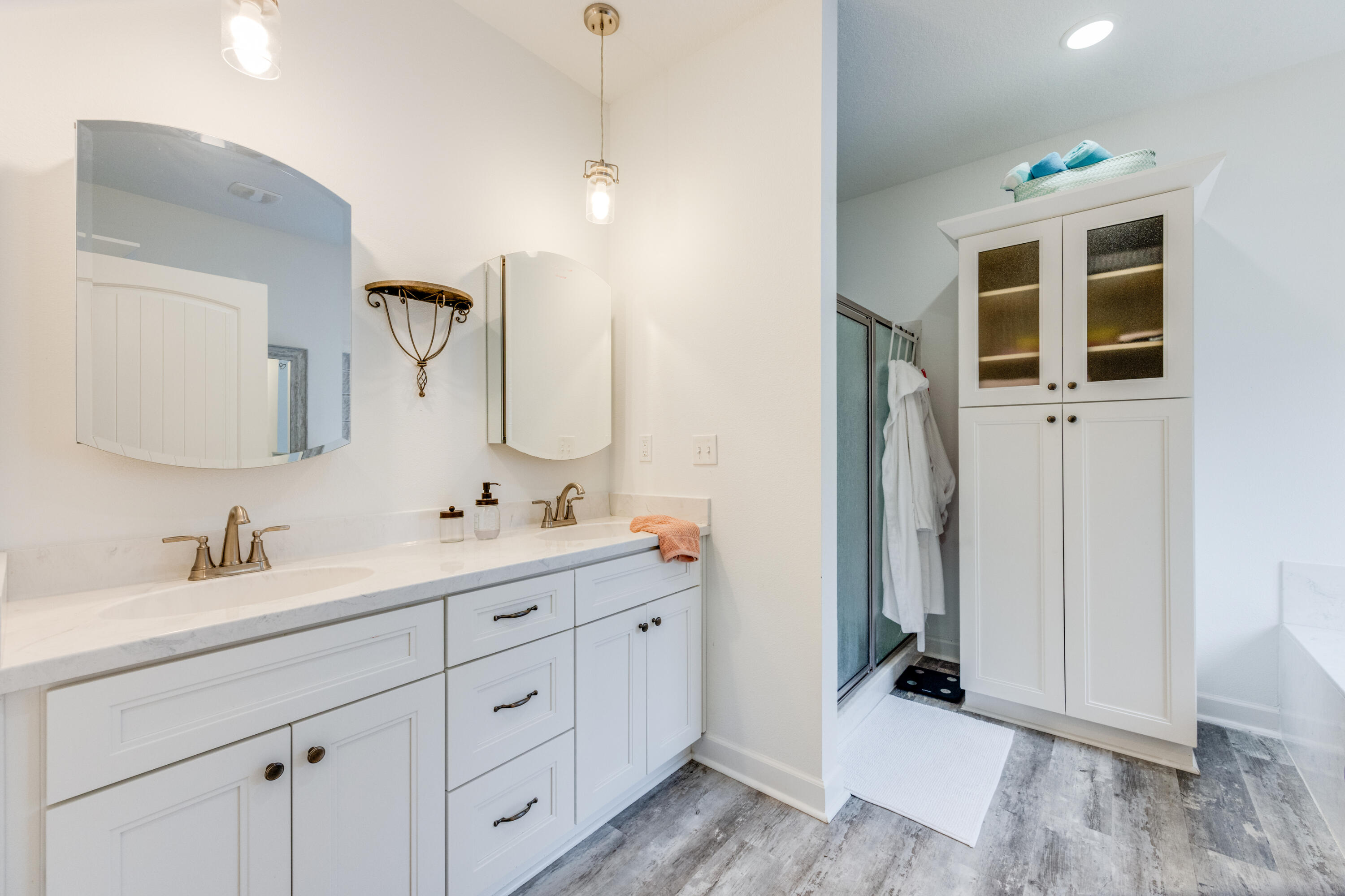 4444 Wilkerson Bluff Road Holt, FL 32564 - Photo 11 of 32 a spacious bathroom with a double vanity sink a mirror and a shower