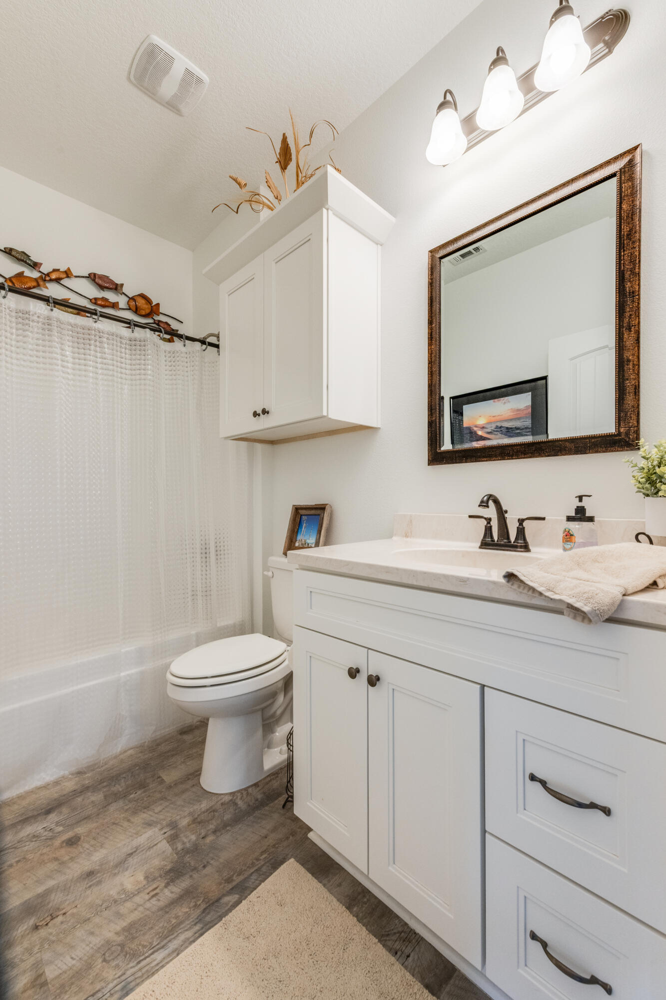 4444 Wilkerson Bluff Road Holt, FL 32564 - Photo 19 of 32 a bathroom with a toilet sink and mirror