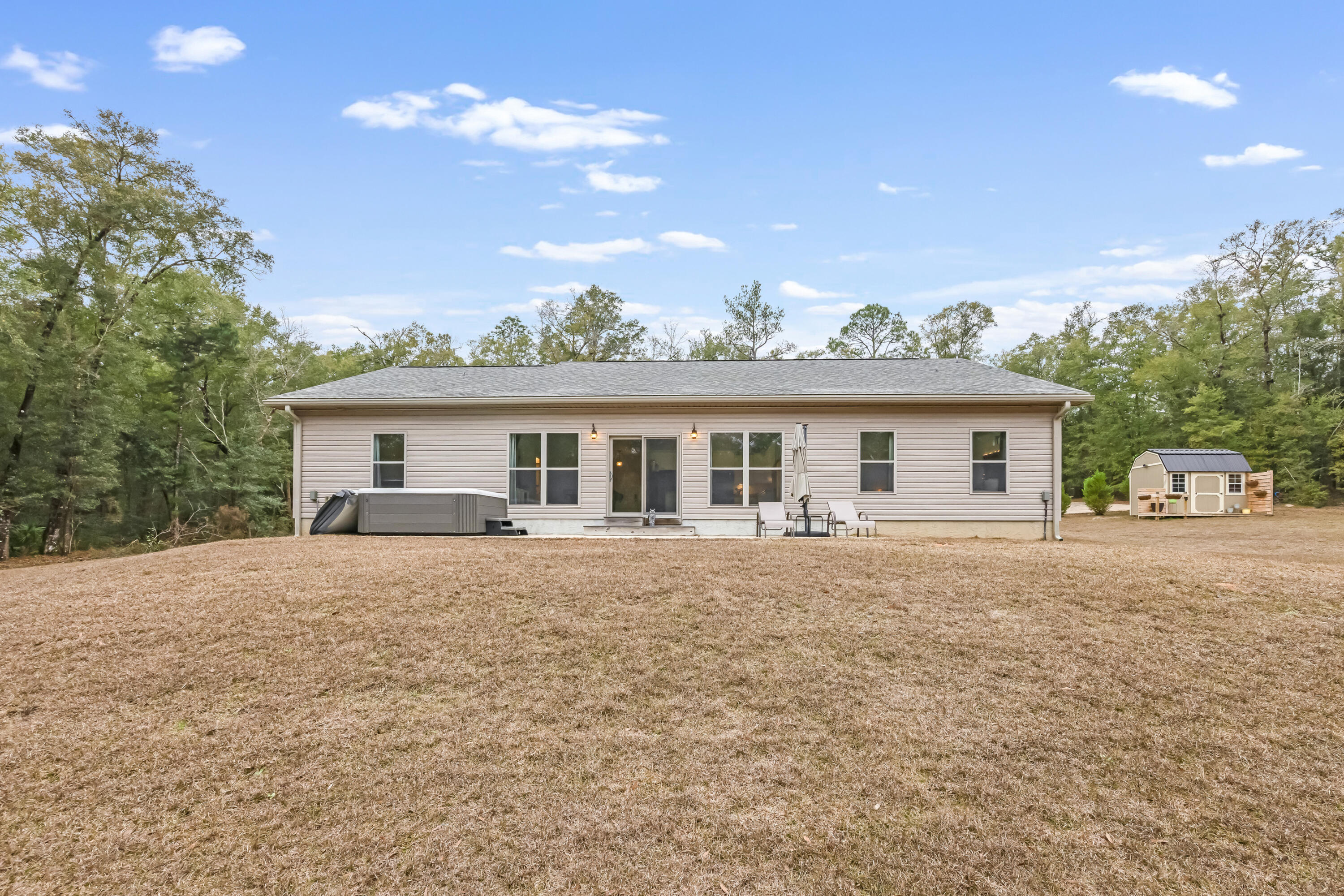 4444 Wilkerson Bluff Road Holt, FL 32564 - Photo 22 of 32 a front view of house with yard and trees