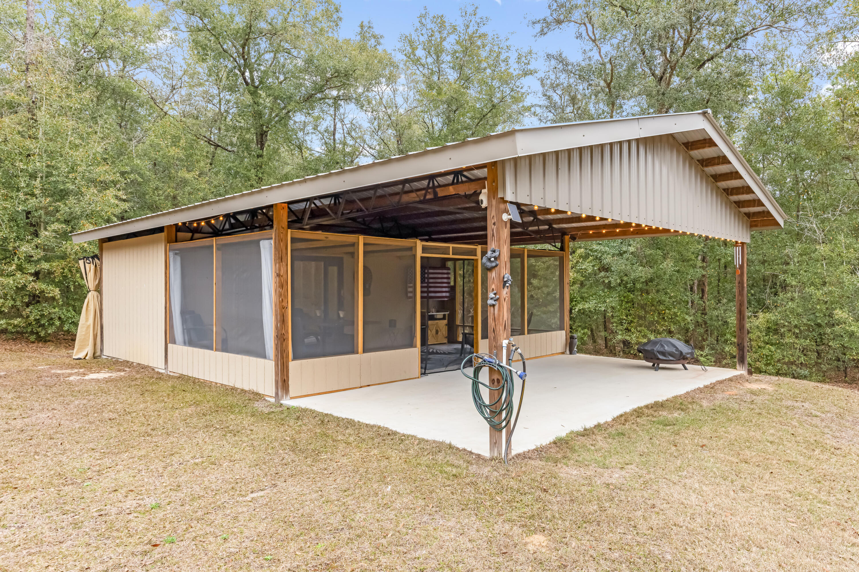 4444 Wilkerson Bluff Road Holt, FL 32564 - Photo 23 of 32 a view of house with backyard and outdoor seating