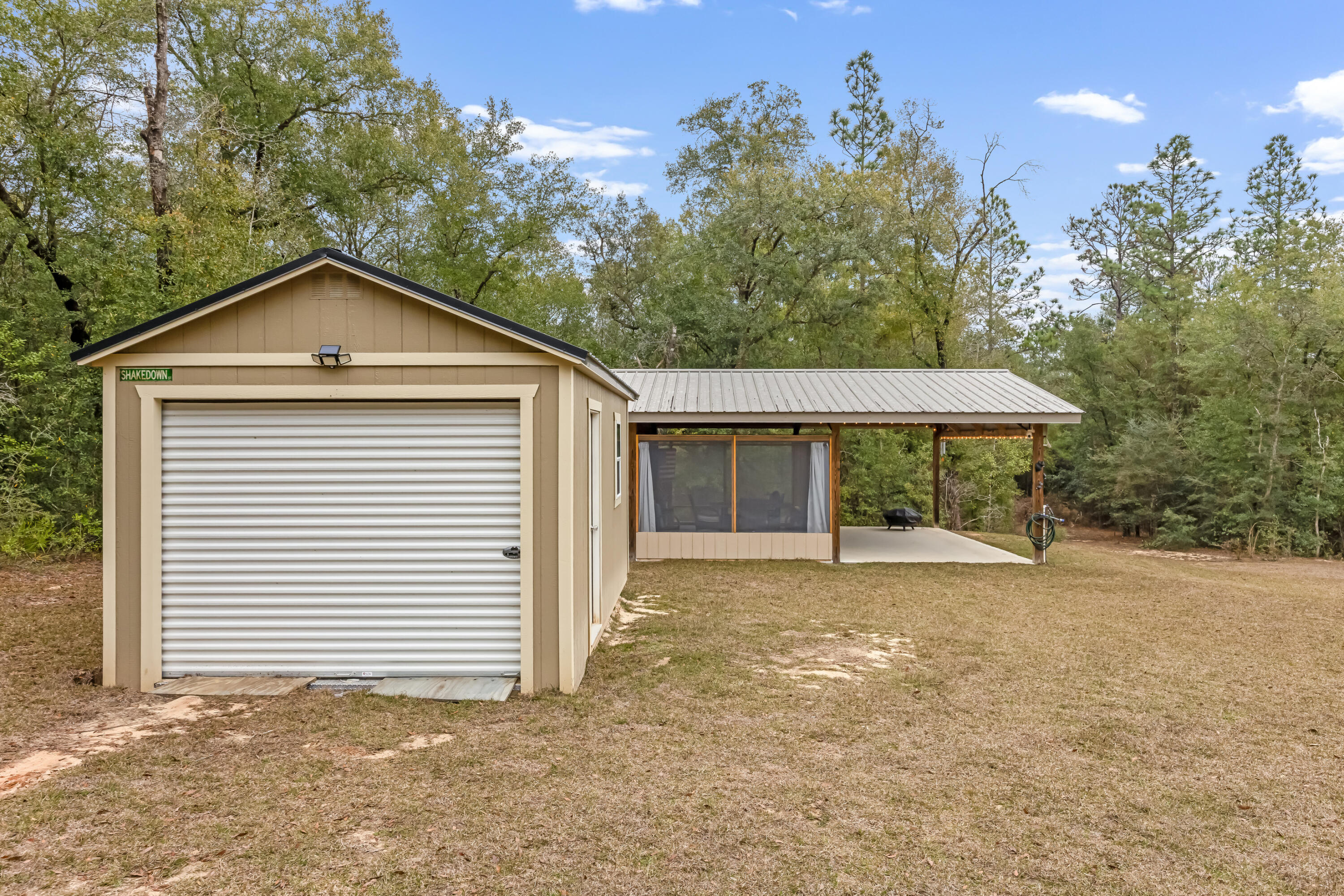 4444 Wilkerson Bluff Road Holt, FL 32564 - Photo 28 of 32 a front view of a house with a yard and garage
