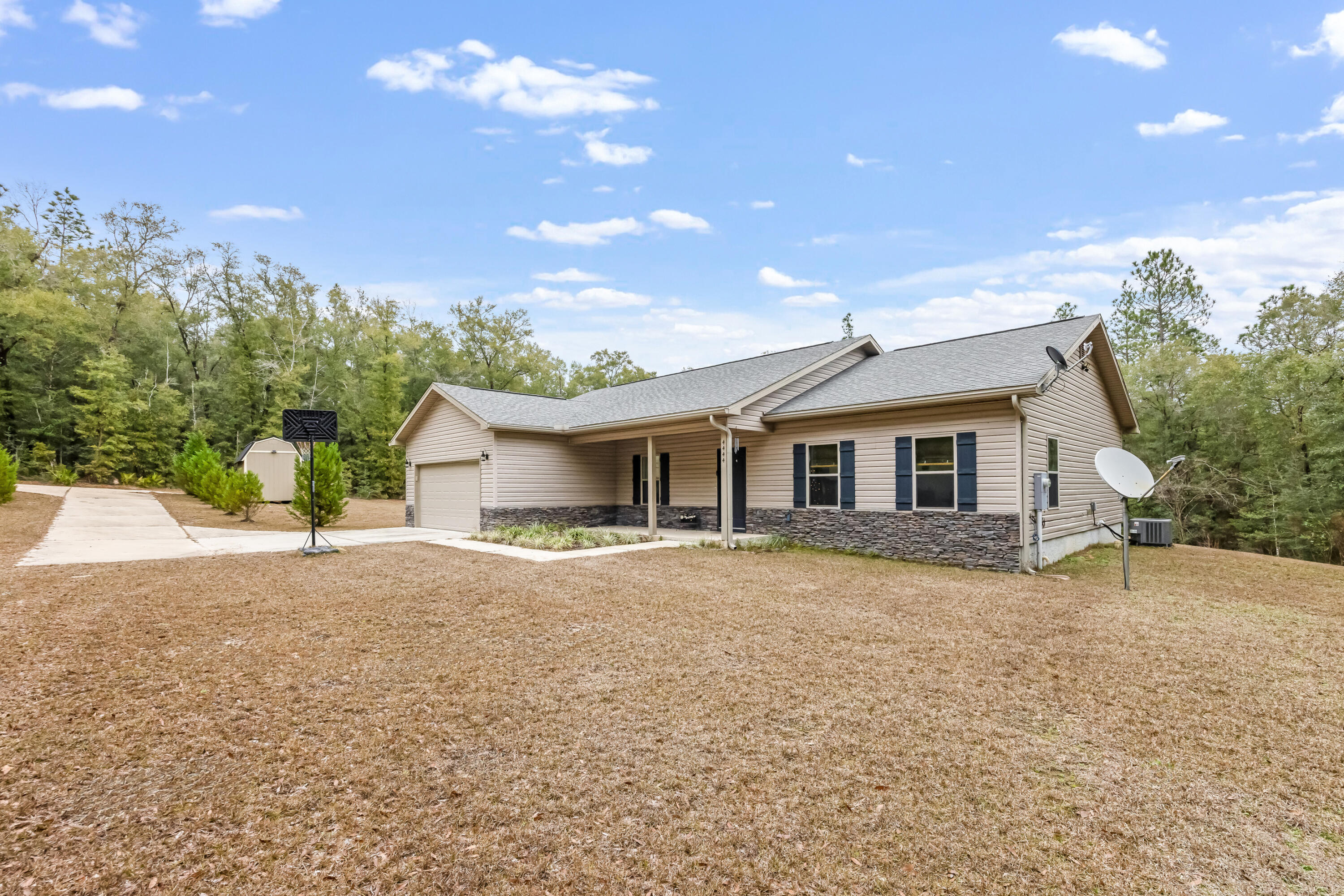 4444 Wilkerson Bluff Road Holt, FL 32564 - Photo 3 of 32 a front view of a house with a yard and garage