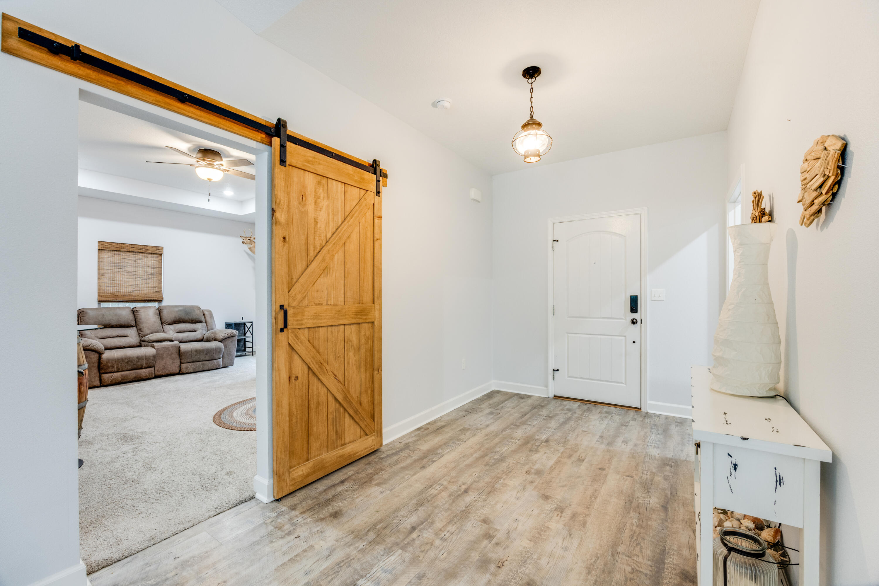4444 Wilkerson Bluff Road Holt, FL 32564 - Photo 5 of 32 a view of a livingroom with wooden floor and a ceiling fan