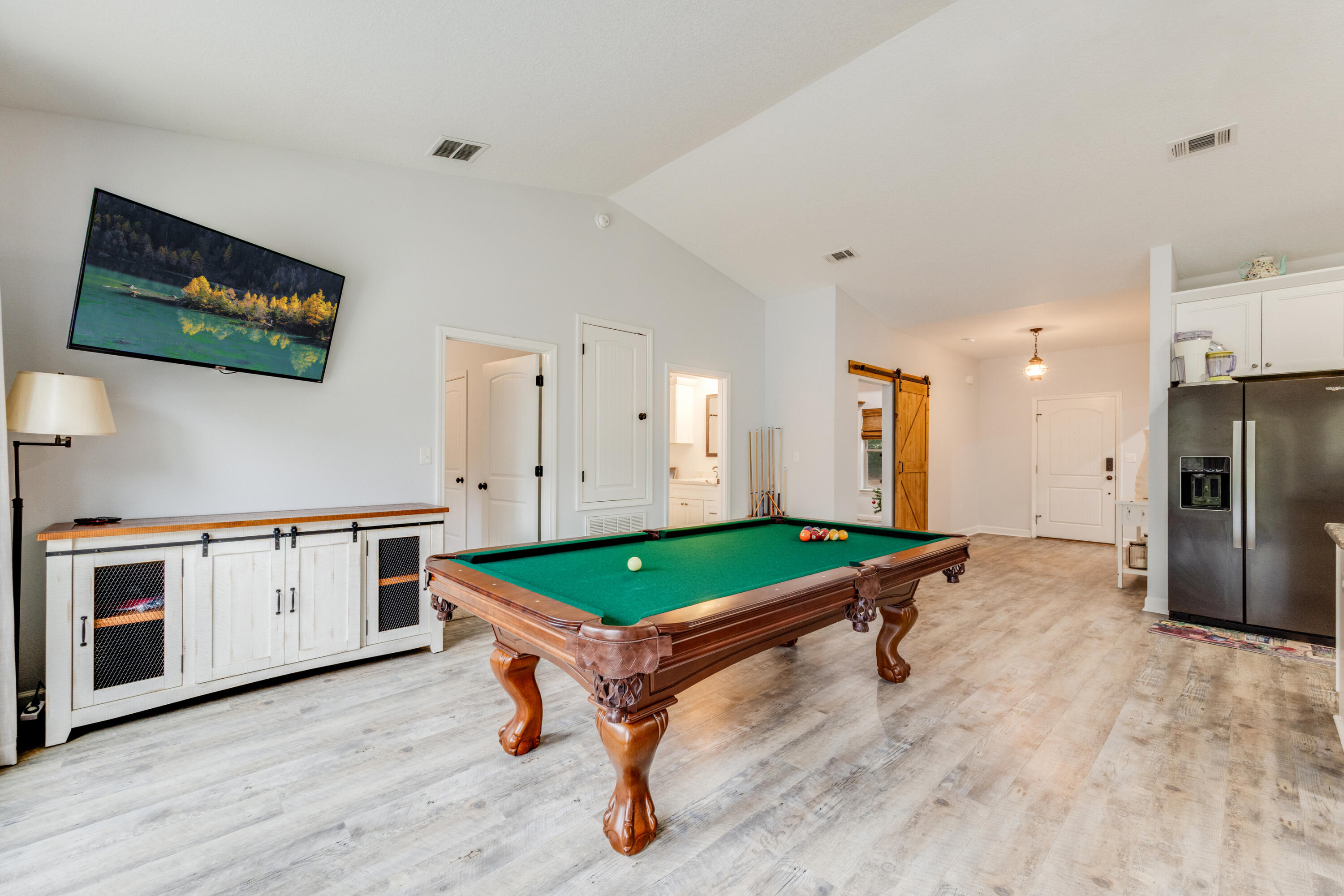 4444 Wilkerson Bluff Road Holt, FL 32564 - Photo 7 of 32 a room with furniture pool table flat screen tv and refrigerator