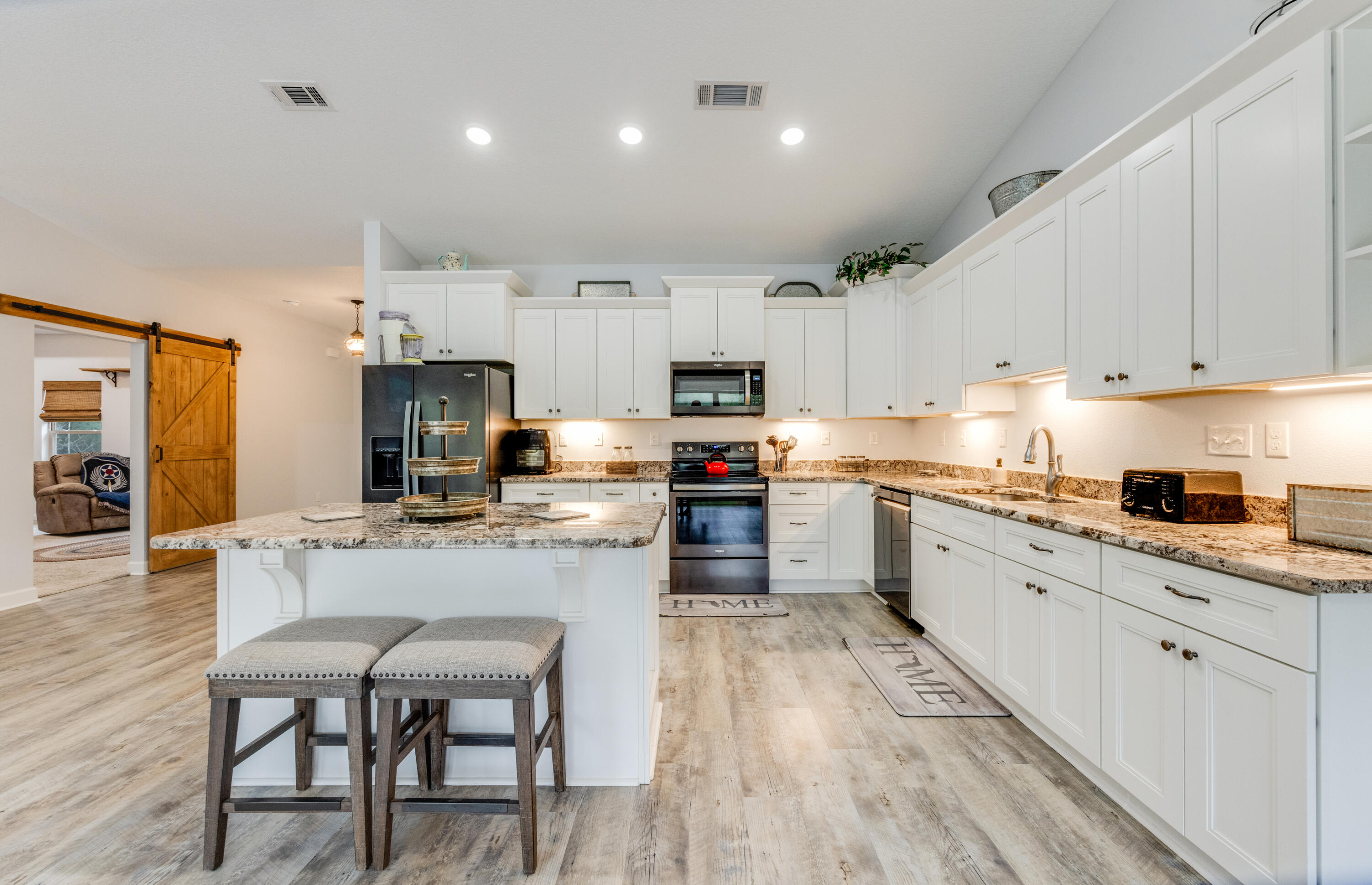 4444 Wilkerson Bluff Road Holt, FL 32564 - Photo 8 of 32 a kitchen with kitchen island granite countertop lots of counter top space and stainless steel appliances
