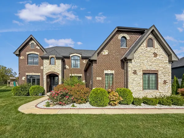 a front view of a house with a yard
