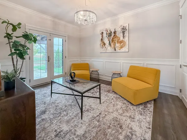 a living room with furniture and a potted plant