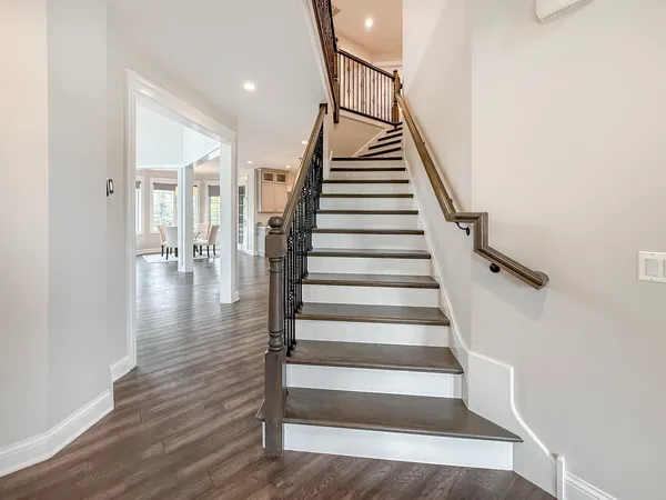 a view of entryway and hall with wooden floor