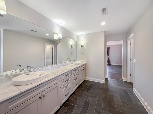 a spacious bathroom with a double vanity sink and a mirror