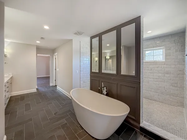 a spacious bathroom with a bathtub and shower